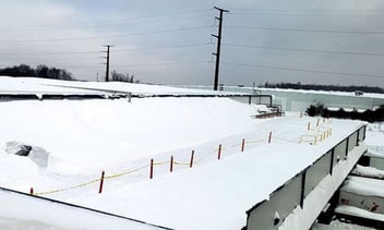 Snow Piled on Roof of Facility